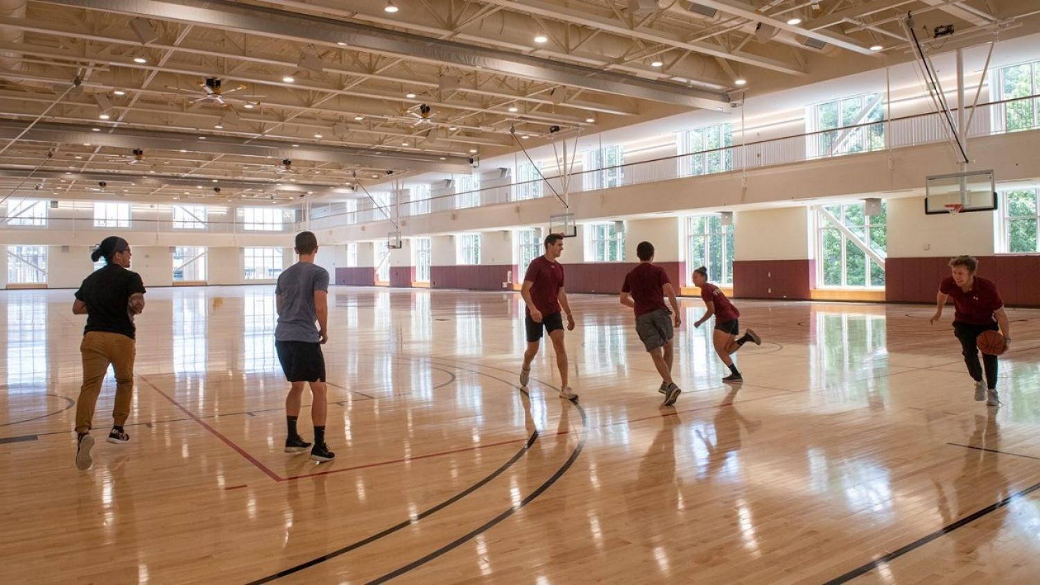 A group of students plays basketball on the new Recreation Center courts