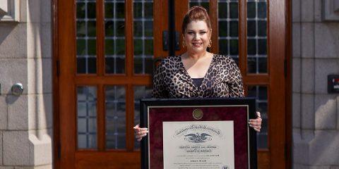 Dina Coughlan holding her diploma